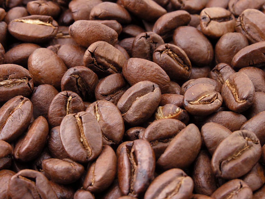 A pile of dark roasted coffee beans