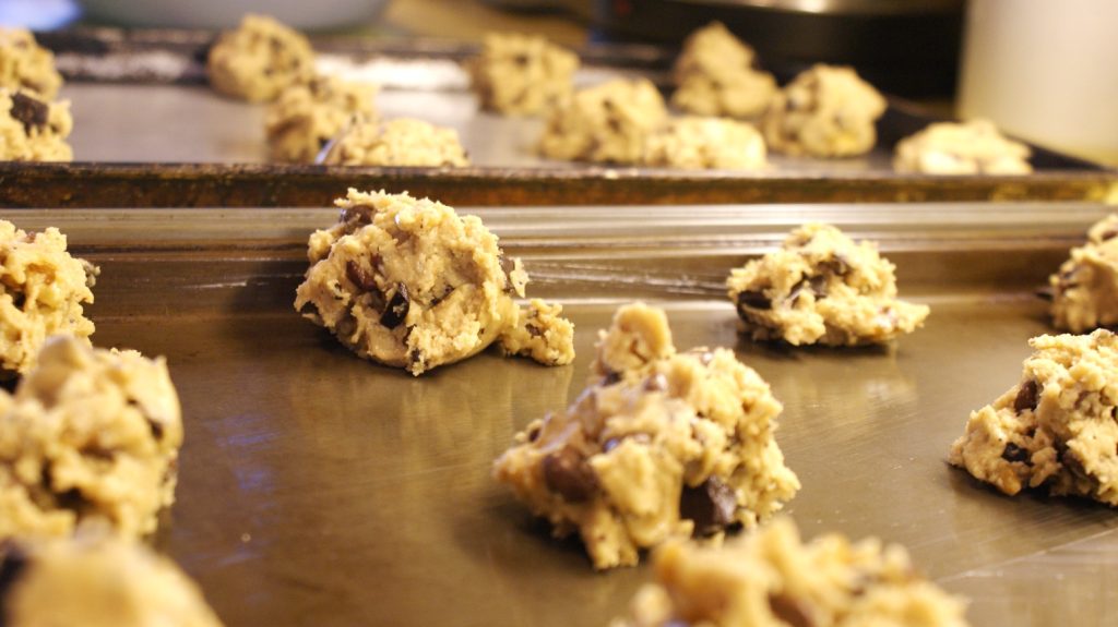 Scoops of cookie dough on a baking sheet ready for the oven