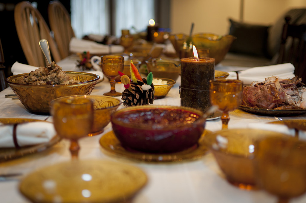 Festive dinner table laid with plates, glasses and candles