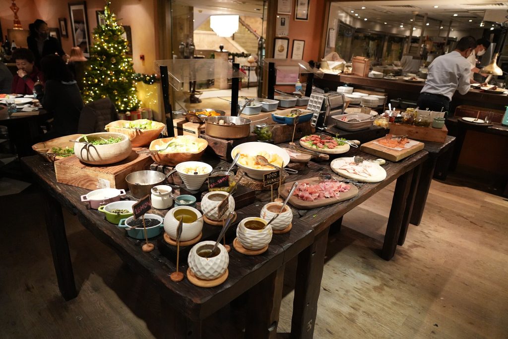 A holiday grazing board with cheeses, cured meats, crackers and grapes