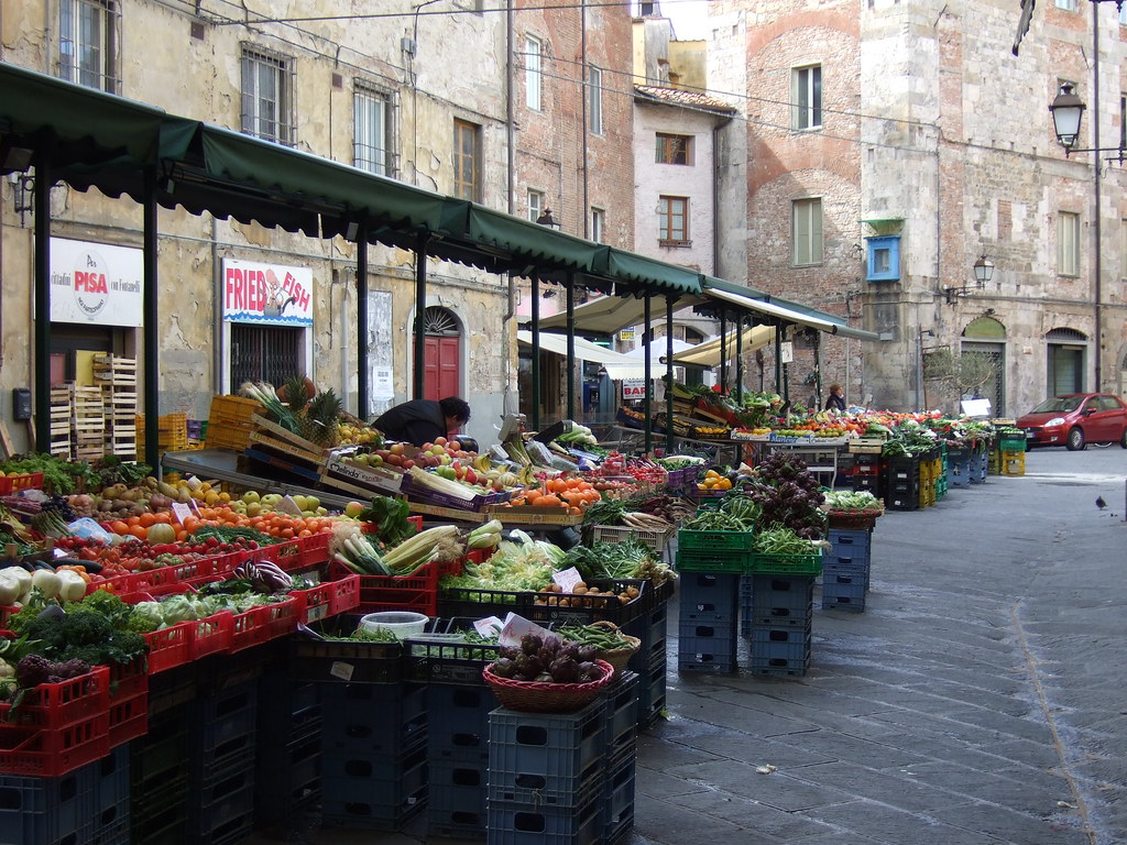 Colourful fresh fruit and vegetables stacked at a market stall
