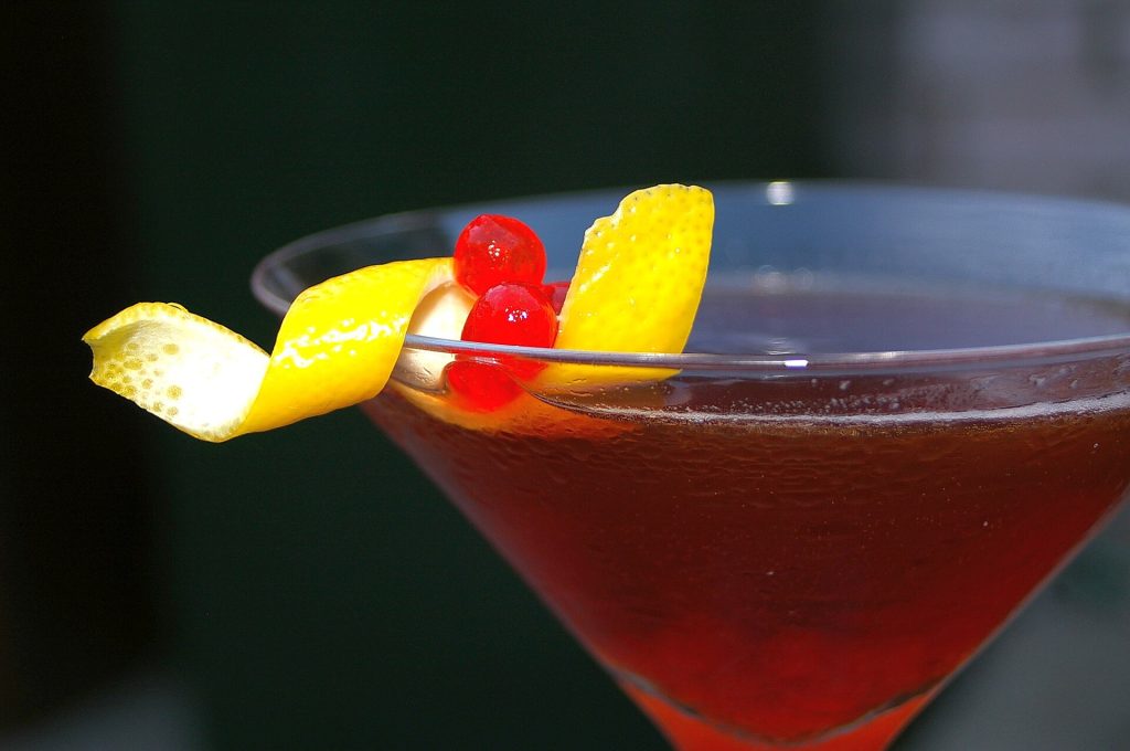 A Manhattan cocktail with a cherry garnish