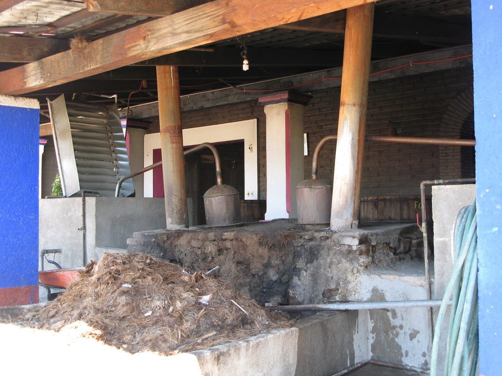 Traditional mezcal distillery with a copper still