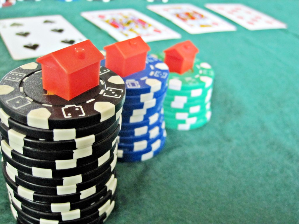 Playing cards and stacked poker chips on a felt table