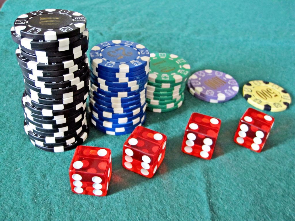 A pair of dice on a green felt table