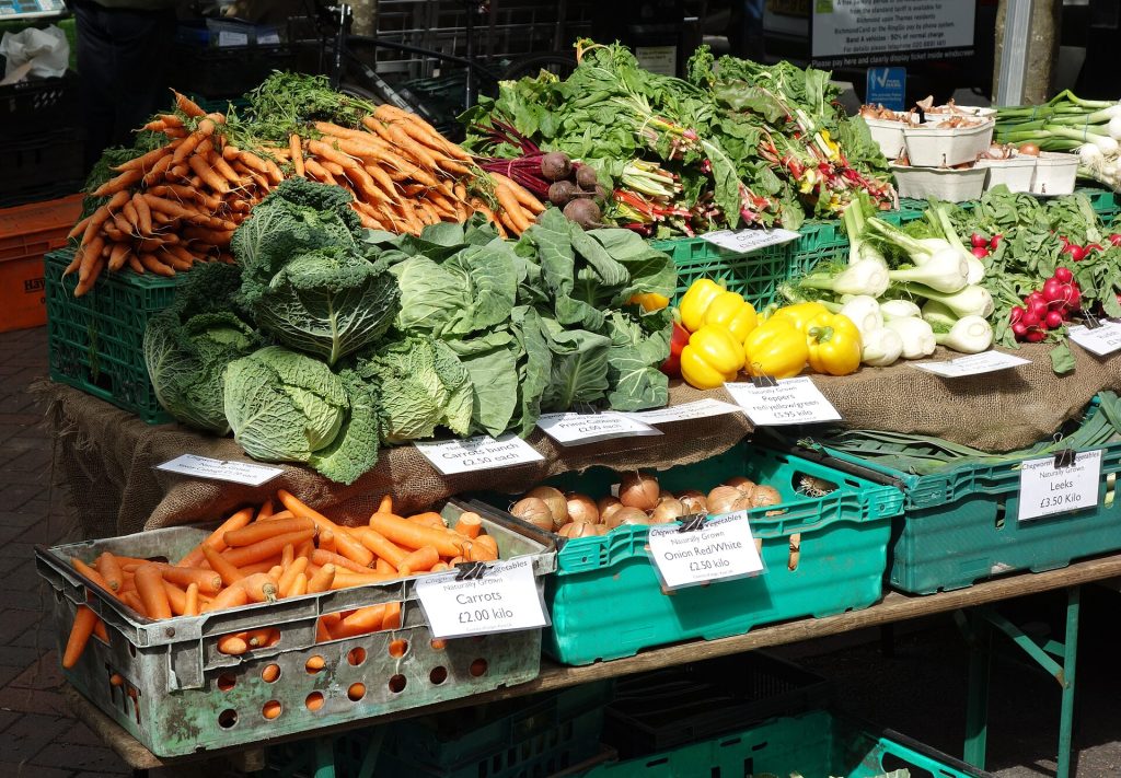 Fresh produce stacked at a farmers market stall